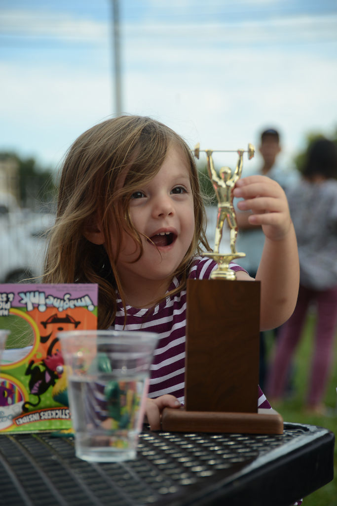 Harriet Boresi, 2, plays with her mother's trophy on Friday, Sep. 13, 2019